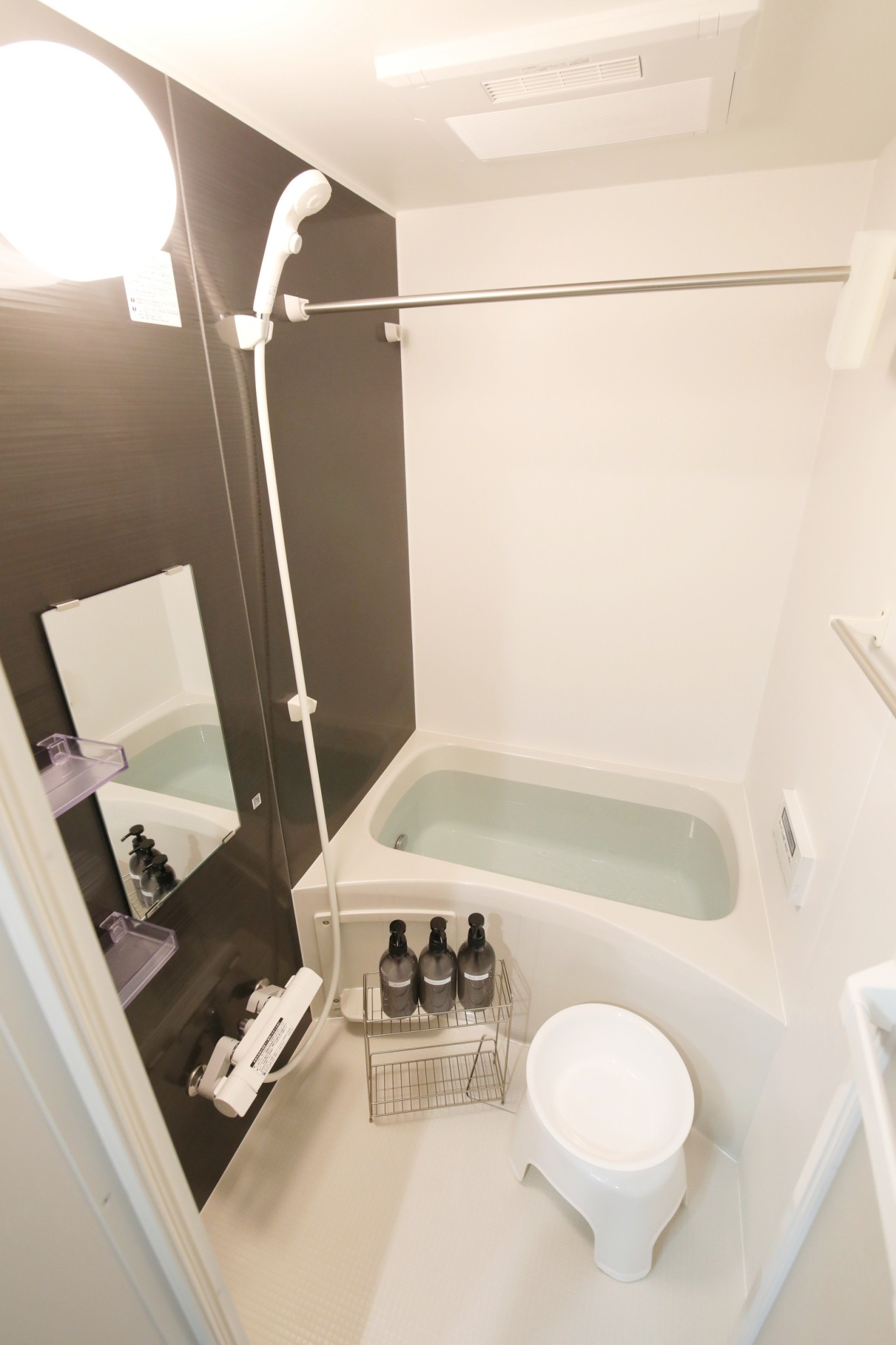 Room 202 bathroom with bathtub and brown accent wall
