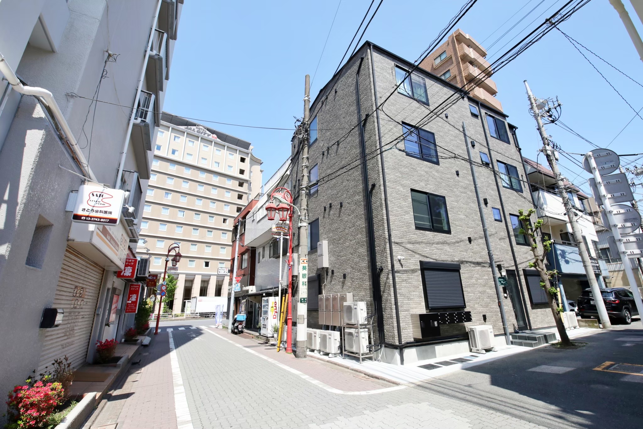 Stark Tokyo Haneda building from the street — full grey brick exterior