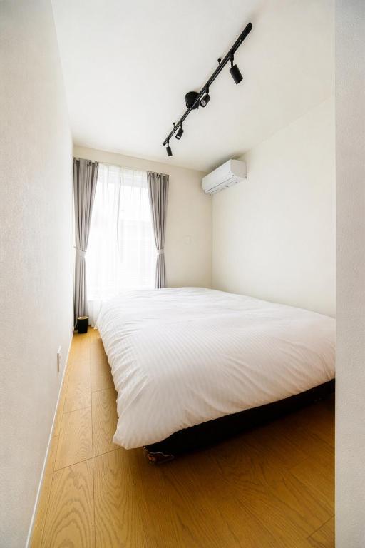Bedroom 3 with double bed and track lighting