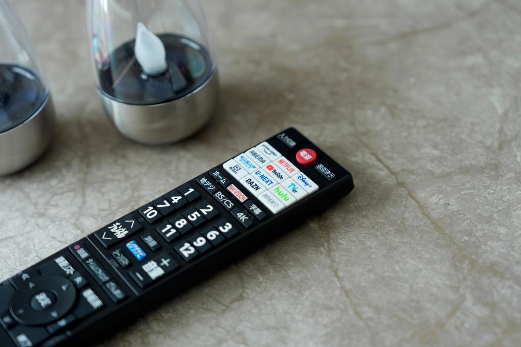 Smart TV remote showing Netflix, YouTube, Disney+